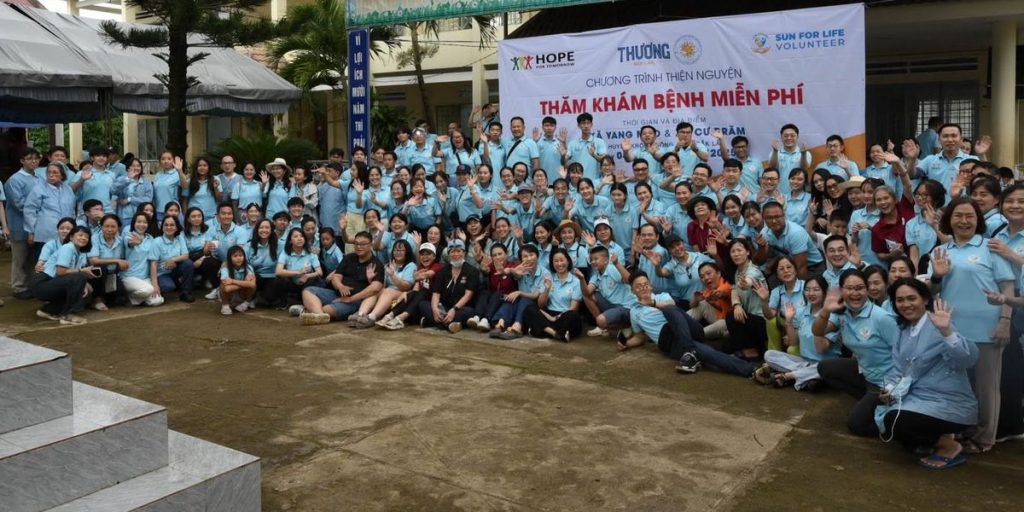 Hope for Tomorrow and Sun For Life volunteers waving at a free medical outreach in Vietnam
